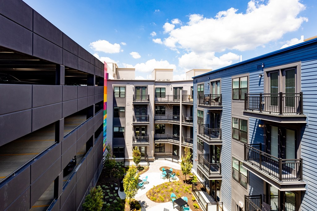 an aerial view of an apartment complex with a pool in the middle