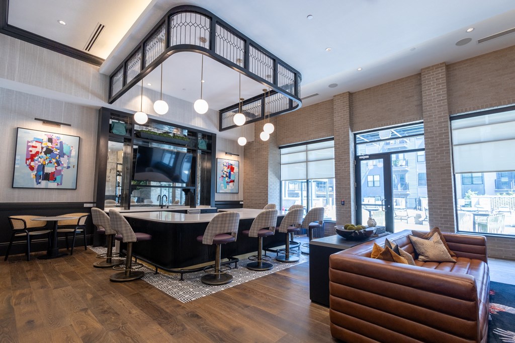 the lobby of a hotel with a bar and a staircase in the ceiling