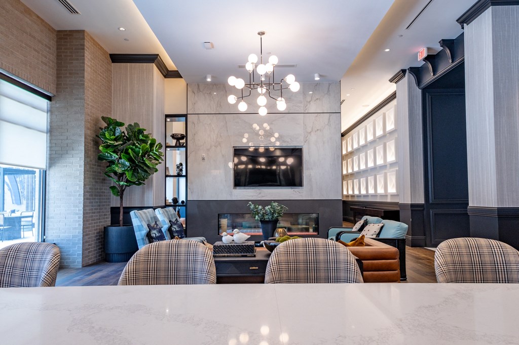 a living room with a fireplace and a table in the foreground
