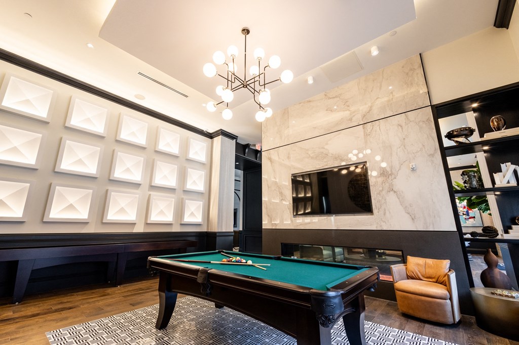 a game room with a pool table and a tv