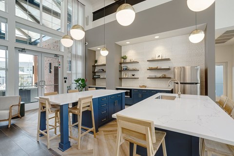 a large kitchen with blue cabinets and a white counter top