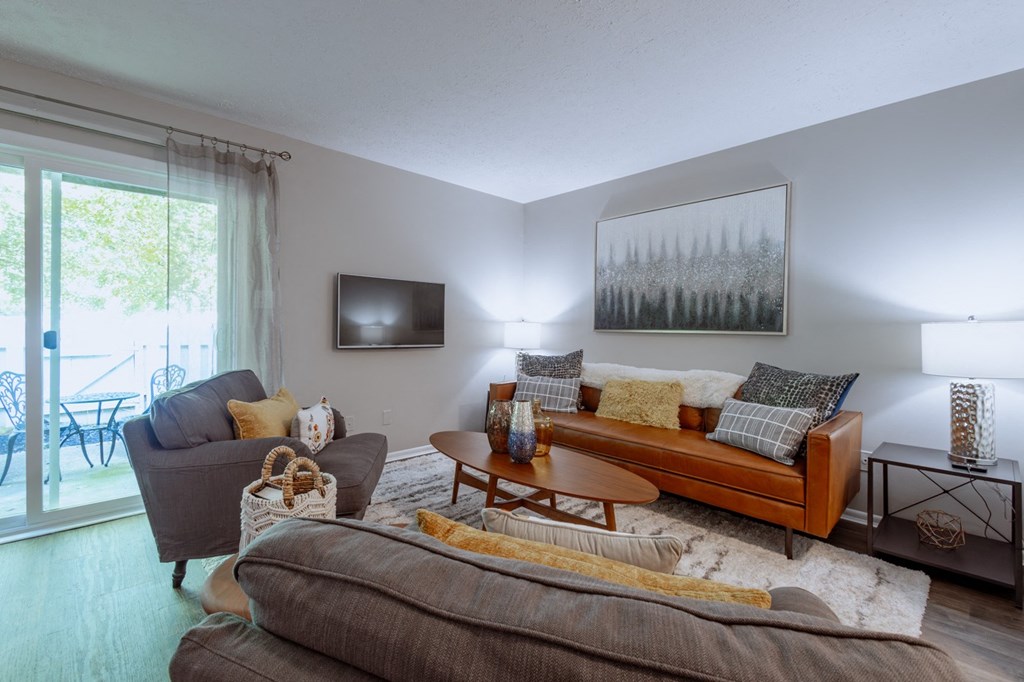 a living room with a couch and a chair and a tv