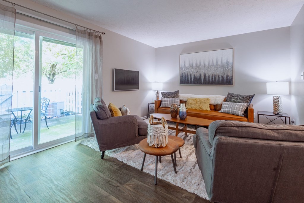 a living room with a sliding glass door to a patio