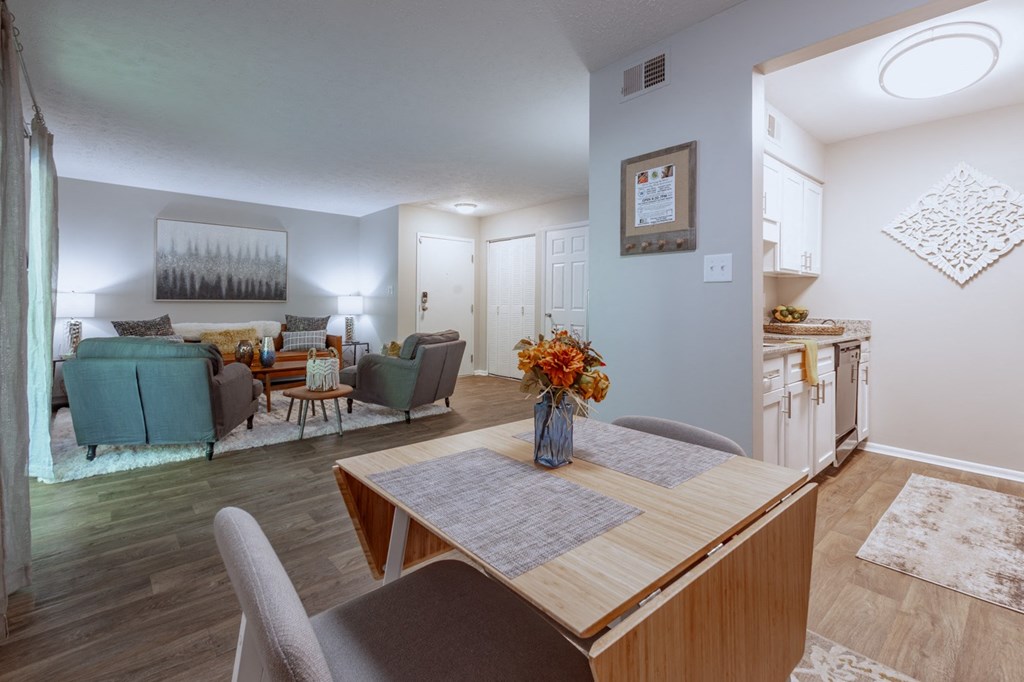 an open living room and dining room with a table and chairs