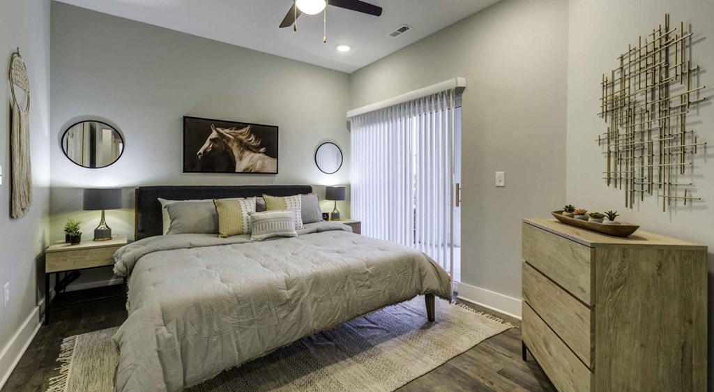 bedroom with bed and night stands with large window at Echo Park at Perry Crossing Apartments, Plainfield