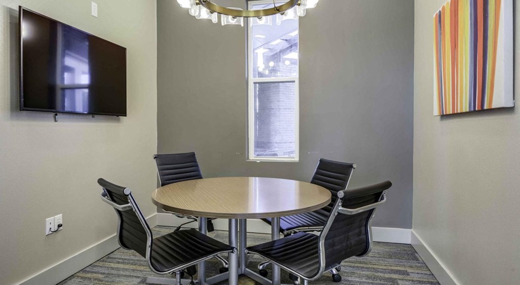 a conference room with a round table and chairs at Echo Park at Perry Crossing Apartments, Plainfield