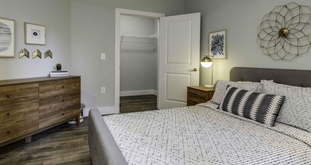 a bedroom with a bed and a closet at Echo Park at Perry Crossing Apartments, Plainfield, IN, 46168