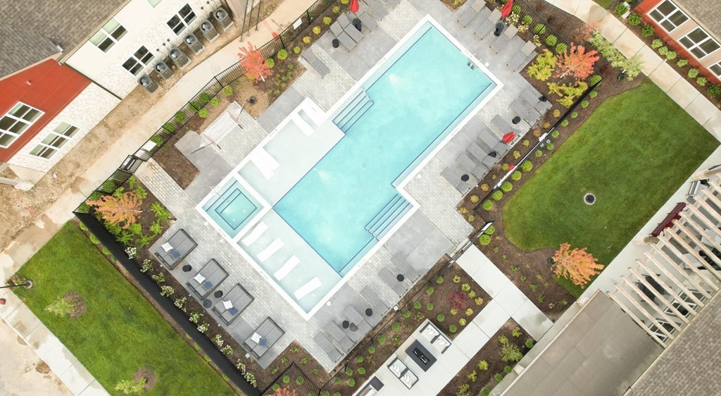an aerial view of a swimming pool in an apartment complex