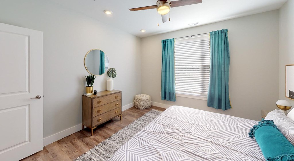 a bedroom with a bed and a ceiling fan at Echo Park at Perry Crossing Apartments, Indiana