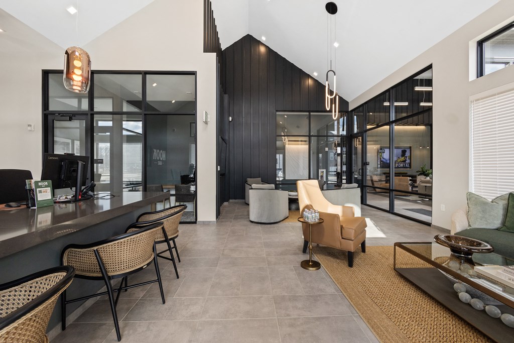 Modern leasing lounge at Nook Nine with high ceilings, stylish seating, and contemporary design.