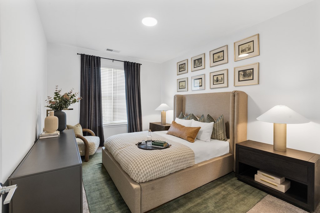 Elegant bedroom at Nook Nine with plush bedding, modern decor, and natural light.