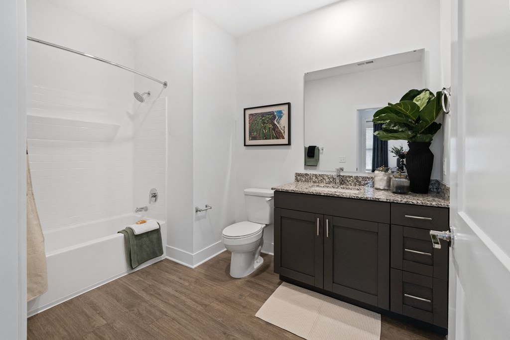 A bathroom with a toilet, a sink, and a shower.