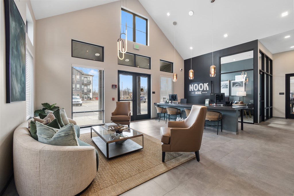 Stylish leasing office at Nook Nine with modern seating, high ceilings, and warm natural light.