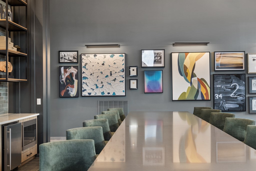 Clubhouse at Nook Nine with modern artwork, sleek dining table, and plush seating.