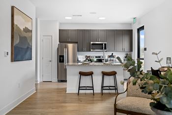 Modern kitchen at Nook Nine with granite countertops, stainless steel appliances, and sleek cabinetry.