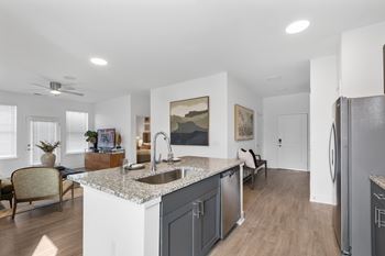 Stylish kitchen at Nook Nine with granite countertops, stainless steel appliances, and open-concept layout.