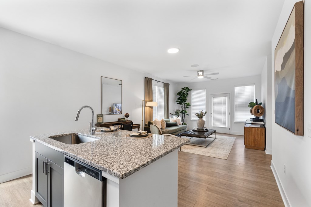 Open-concept kitchen at Nook Nine with granite island, stainless steel appliances, and modern finishes.