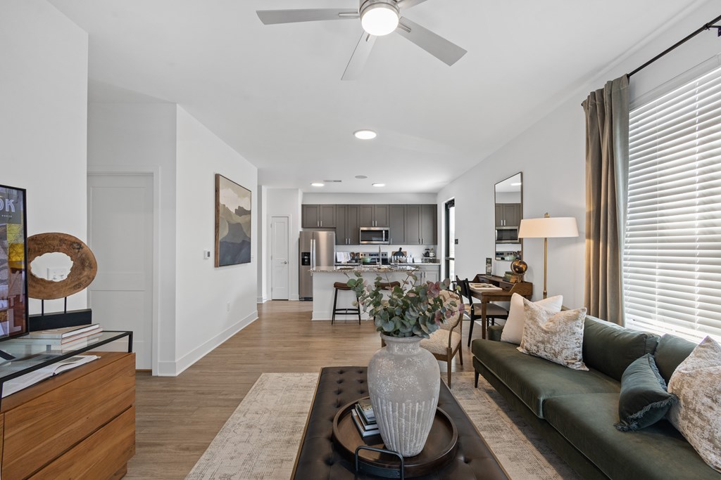 Open-concept living at Nook Nine with a stylish living room, modern kitchen, and wood-style flooring.