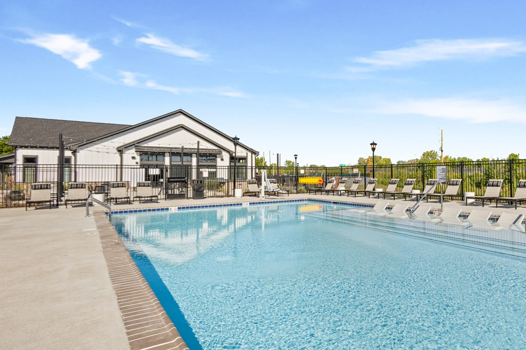 A large swimming pool with a building next to it.
