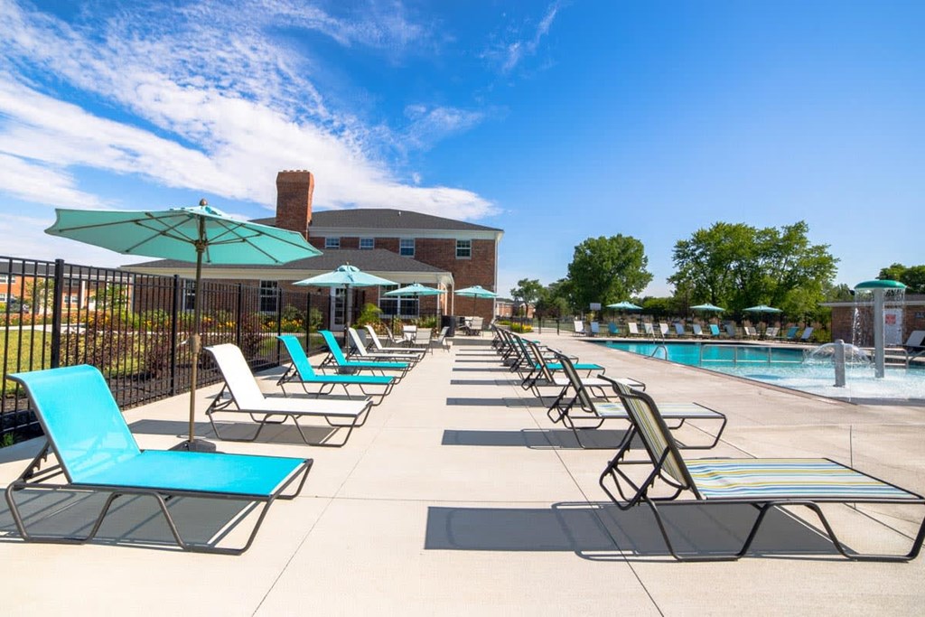 our pool is full of lounge chairs and umbrellas