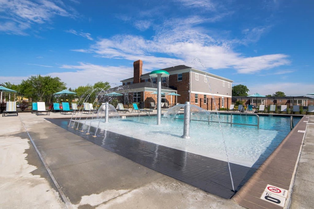 a swimming pool with a building in the background