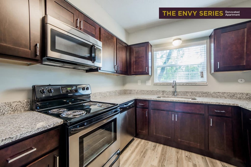a kitchen with wooden cabinets and stainless steel appliances