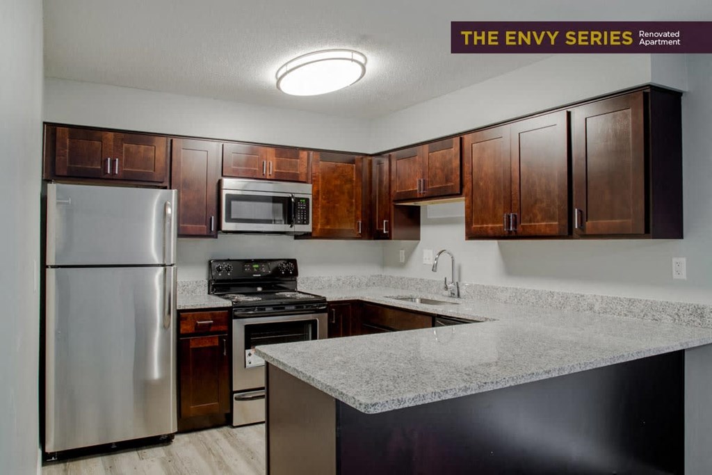 a kitchen with stainless steel appliances and granite counter tops