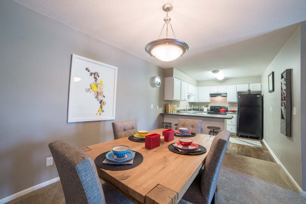 a dining room with a wooden table and chairs