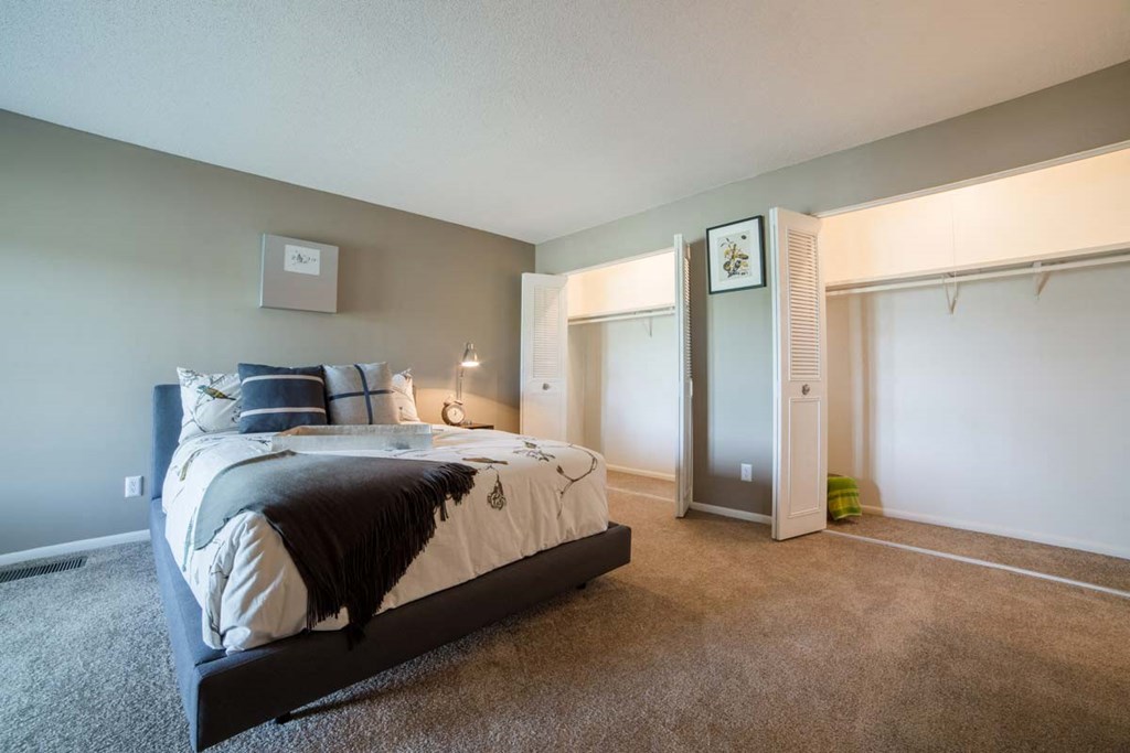 a bedroom with a large bed and a closet