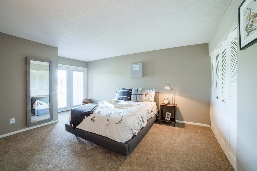 a bedroom with a bed and a window