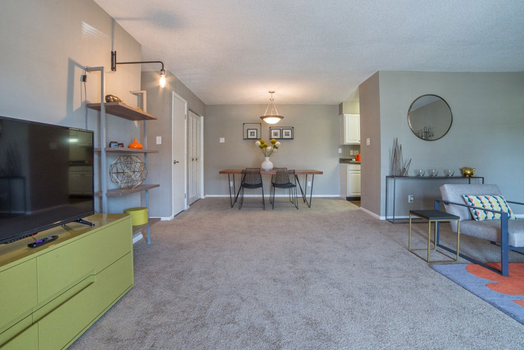 a living room with a couch and a table and a television