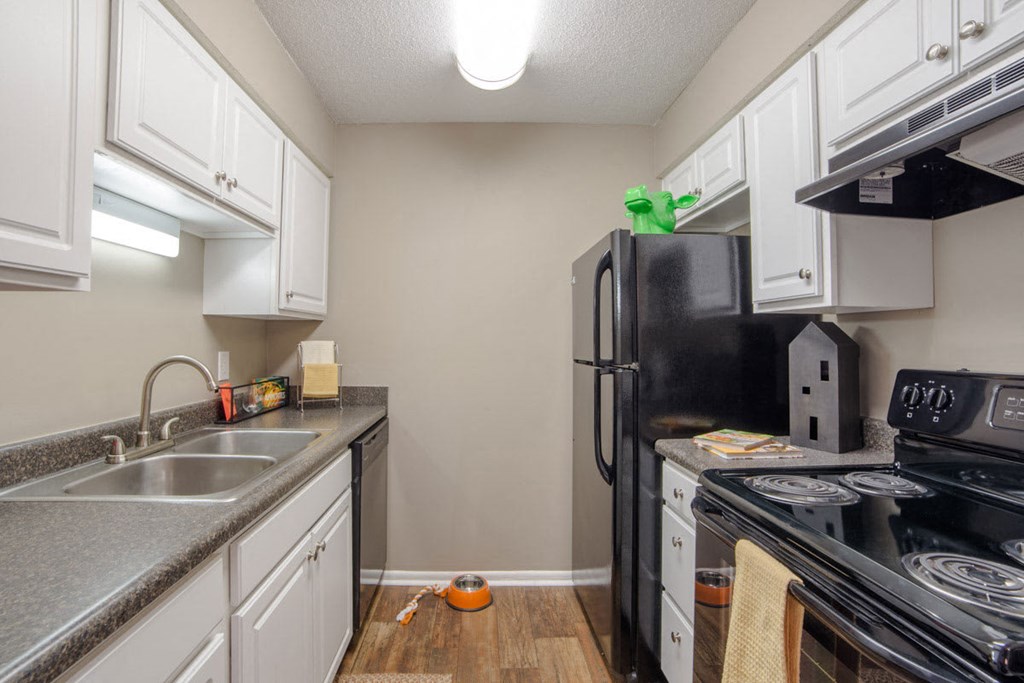 a kitchen with a stove refrigerator and sink
