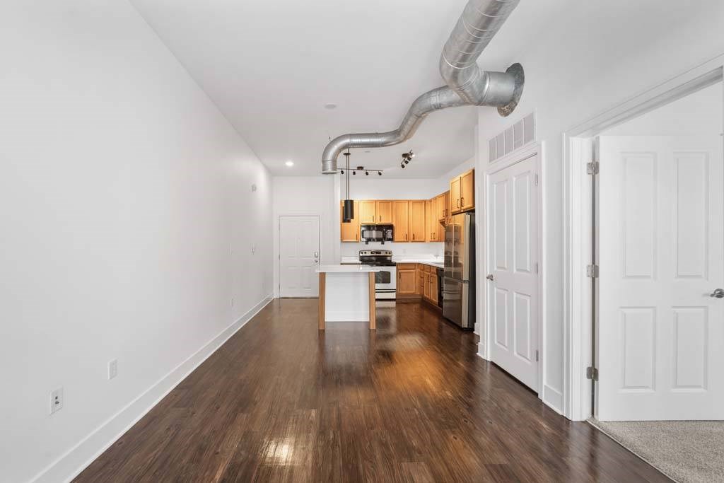 A long, narrow hallway with a kitchen area at The Foundry, South Bend, IN