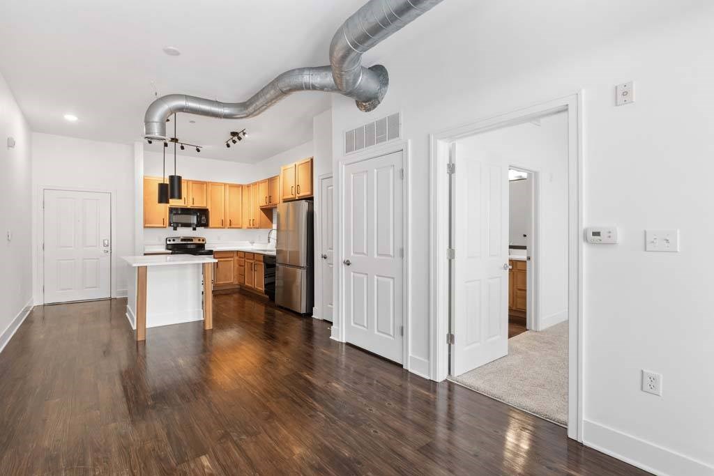 A kitchen with white walls and a wooden floor.at The Foundry, South Bend, 46617