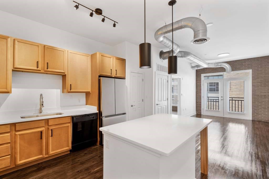 A kitchen with wooden cabinets and a white countertop.at The Foundry, South Bend, 46617