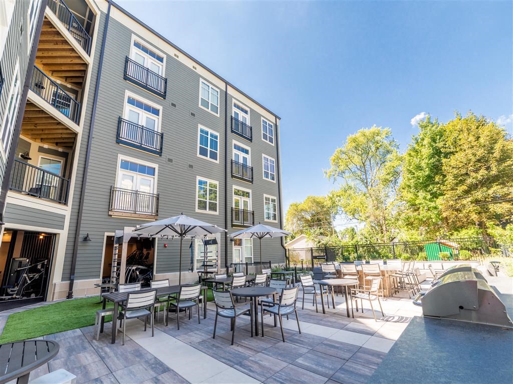 a patio with tables and chairs and a swimming pool at The Foundry, South Bend, IN