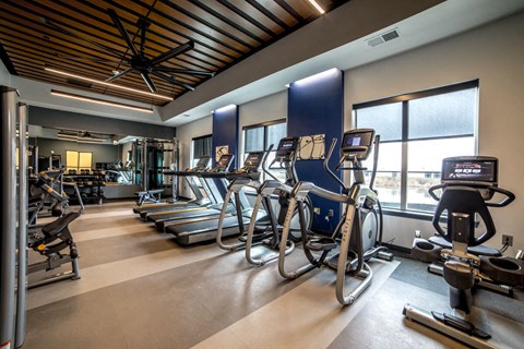 a gym with cardio equipment and windows in a building at The Century at Purdue Research Park-Student, Indiana