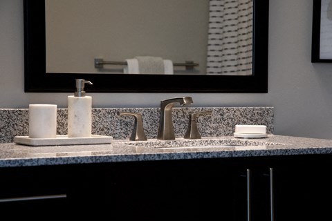 a bathroom with a sink and a mirror in a hotel roomat The Century at Purdue Research Park-Student, West Lafayette, 47906
