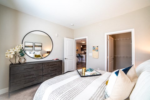a bedroom with a bed and a mirror and a closet at The Century at Purdue Research Park-Student, West Lafayette Indiana