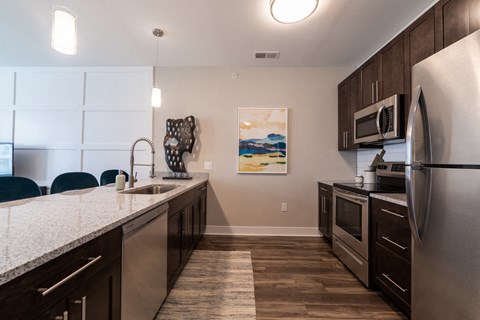 a kitchen with stainless steel appliances and a marble counter topat The Century at Purdue Research Park-Student, West Lafayette, IN 47906