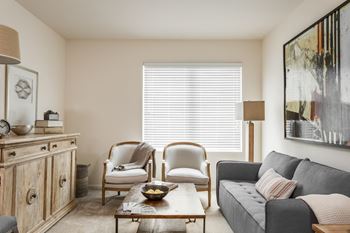 a living room with a couch and two chairs and a coffee table at 310 at Nulu Apartments-Student, Louisville, 40202