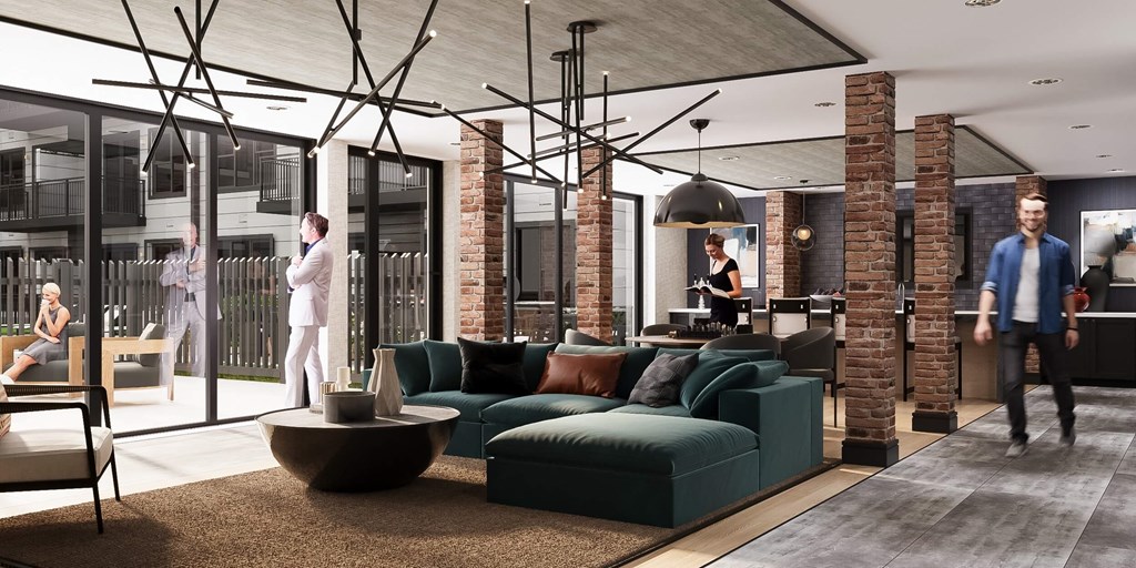 Stylish resident lounge at Contrast OTR in Cincinnati, Ohio, featuring exposed brick accents, modern lighting fixtures, plush seating, and floor-to-ceiling windows for an upscale urban living experience