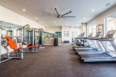 Fitness center with treadmills and weight machines at Indy Living Apartments, Indiana