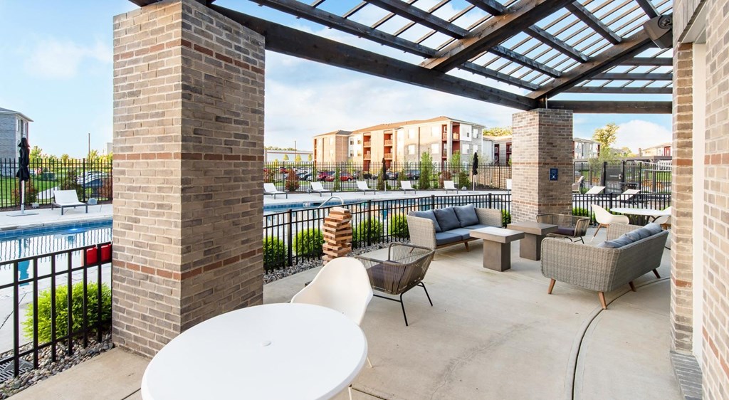 a patio with furniture and a pool at aria on the strip apartments at Echo Park at Perry Crossing Apartments, Plainfield, IN