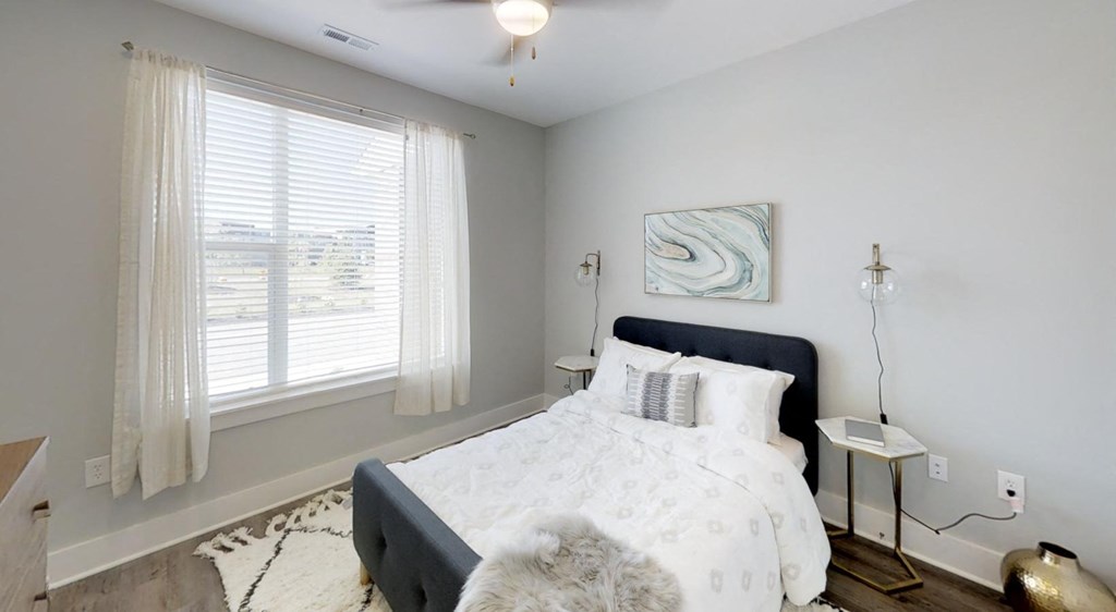 a bedroom with a bed and a large window at Echo Park at Perry Crossing Apartments, Plainfield, IN, 46168