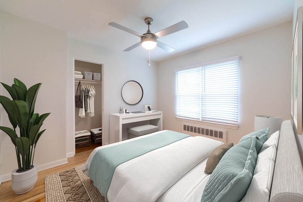 a bedroom with a bed and a ceiling fan