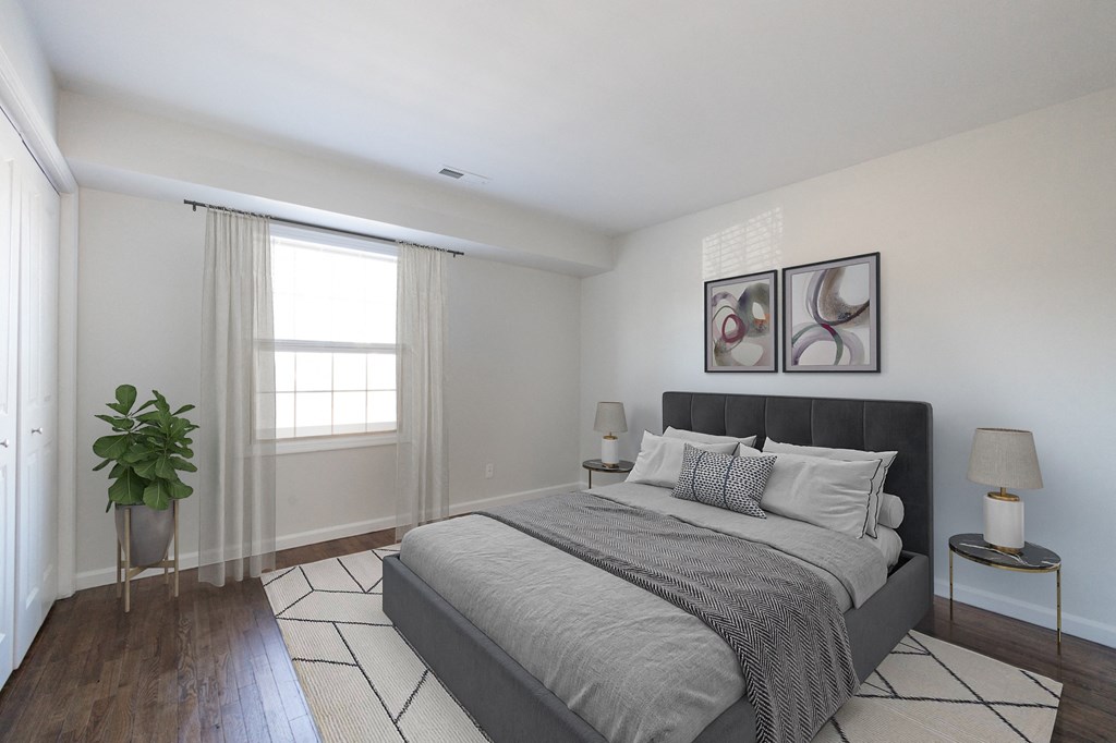 a bedroom with a large bed and a large window