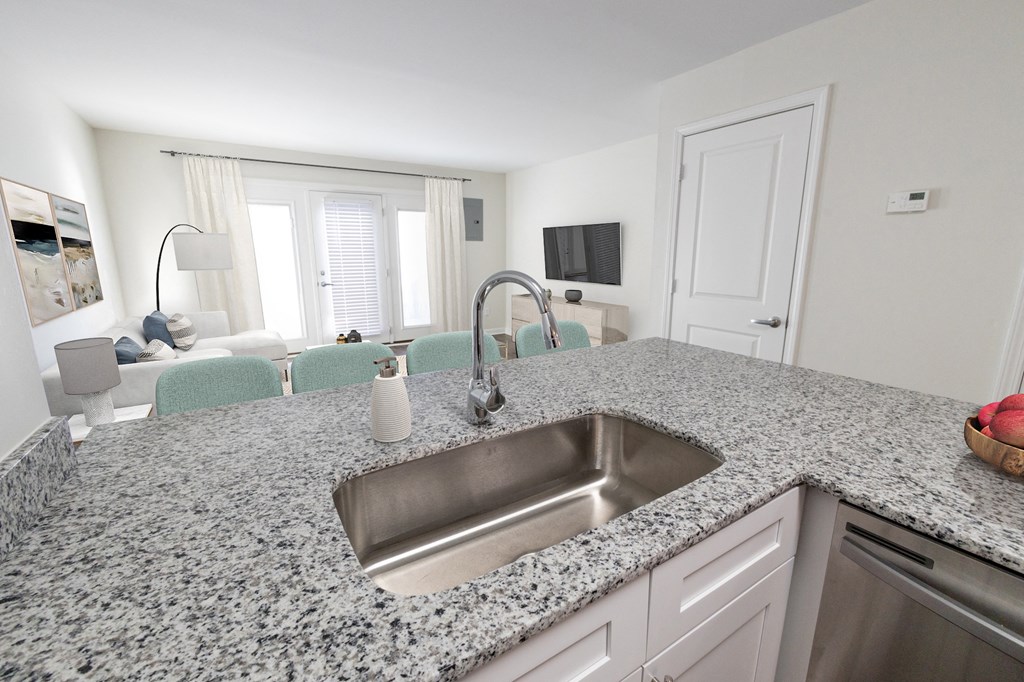 a kitchen with granite countertops and a stainless steel sink