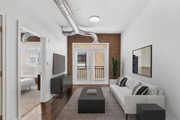 A living room with a couch, a television, and a coffee table.