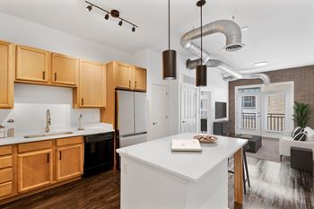 A modern kitchen with wooden cabinets and a white island.